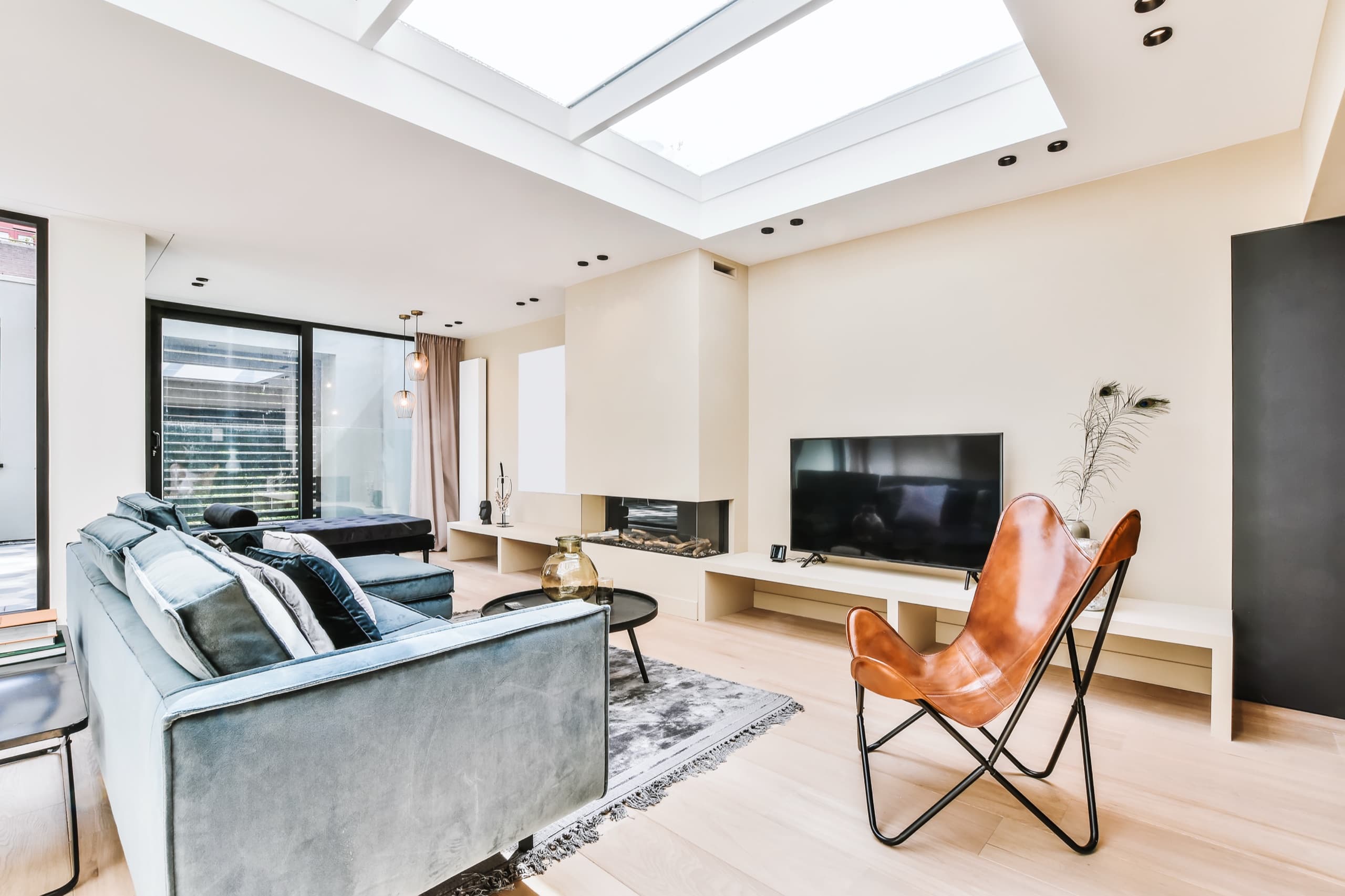 Bright living room with a skylight and spotless wood floors