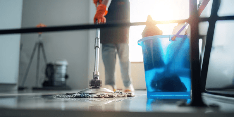 Mop and bucket gliding across a clean floor